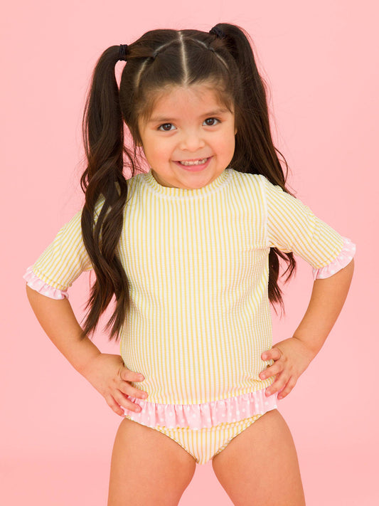 RuffleButts + RuggedButts - Girls Banana Seersucker Short Sleeve Ruffle Rash Guard 2-Piece Swimsuit with Signature Rear Ruffles: Yellow / 6